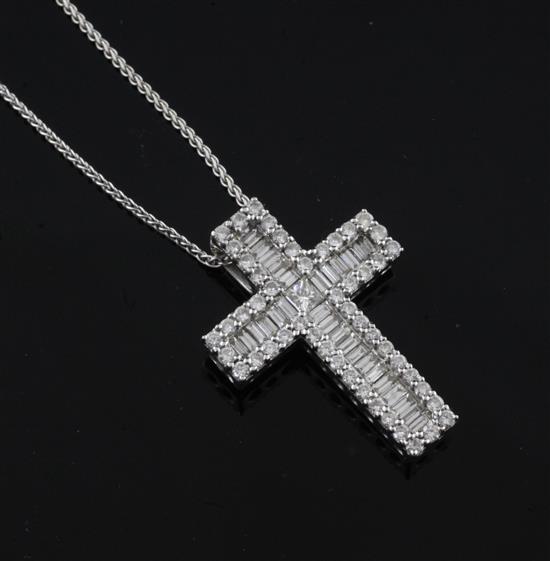 A modern 18ct white gold, baguette and round brilliant cut diamond set cross pendant, pendant 28mm.